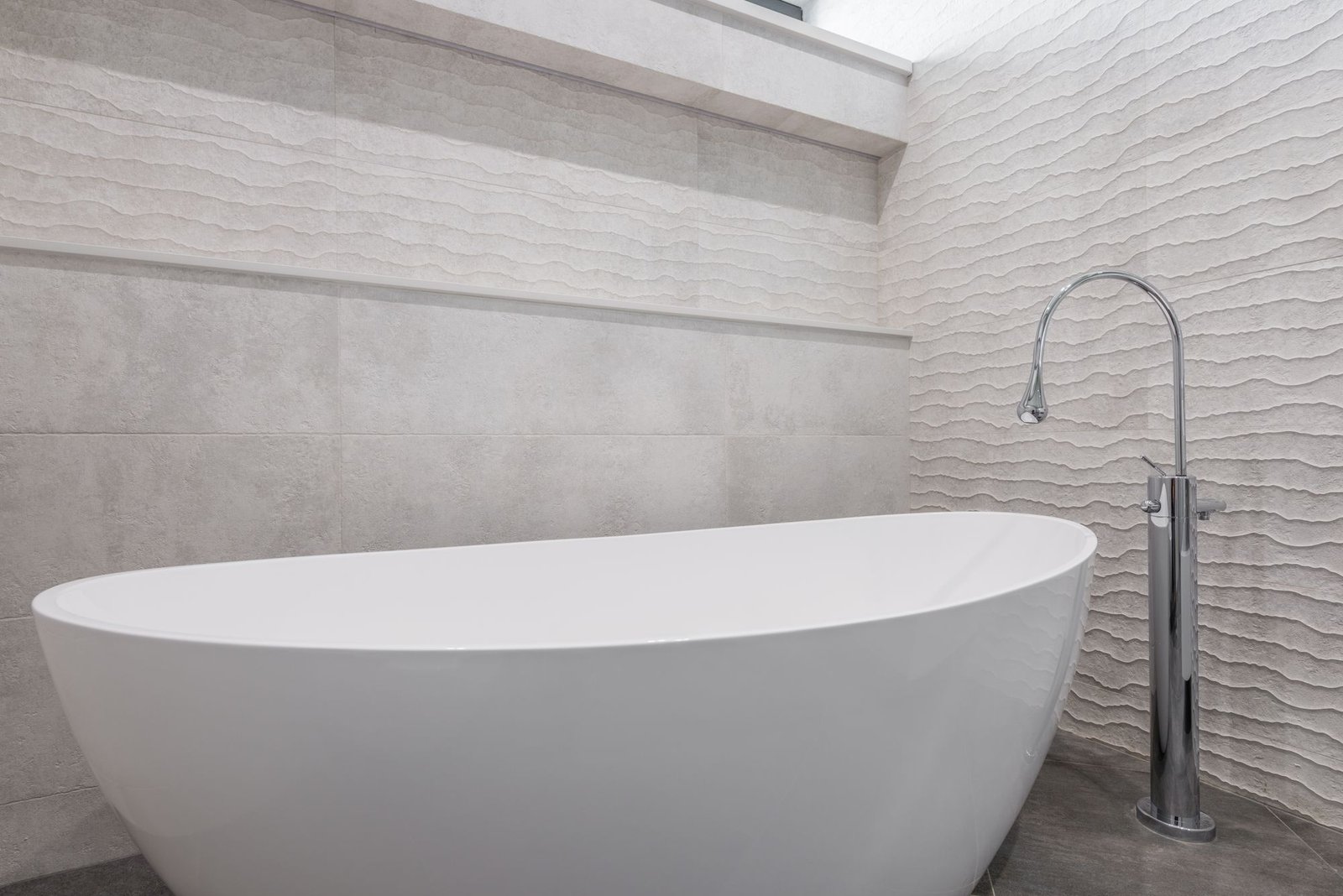 A contemporary bathroom with carefully considered fittings and a calm, natural finish